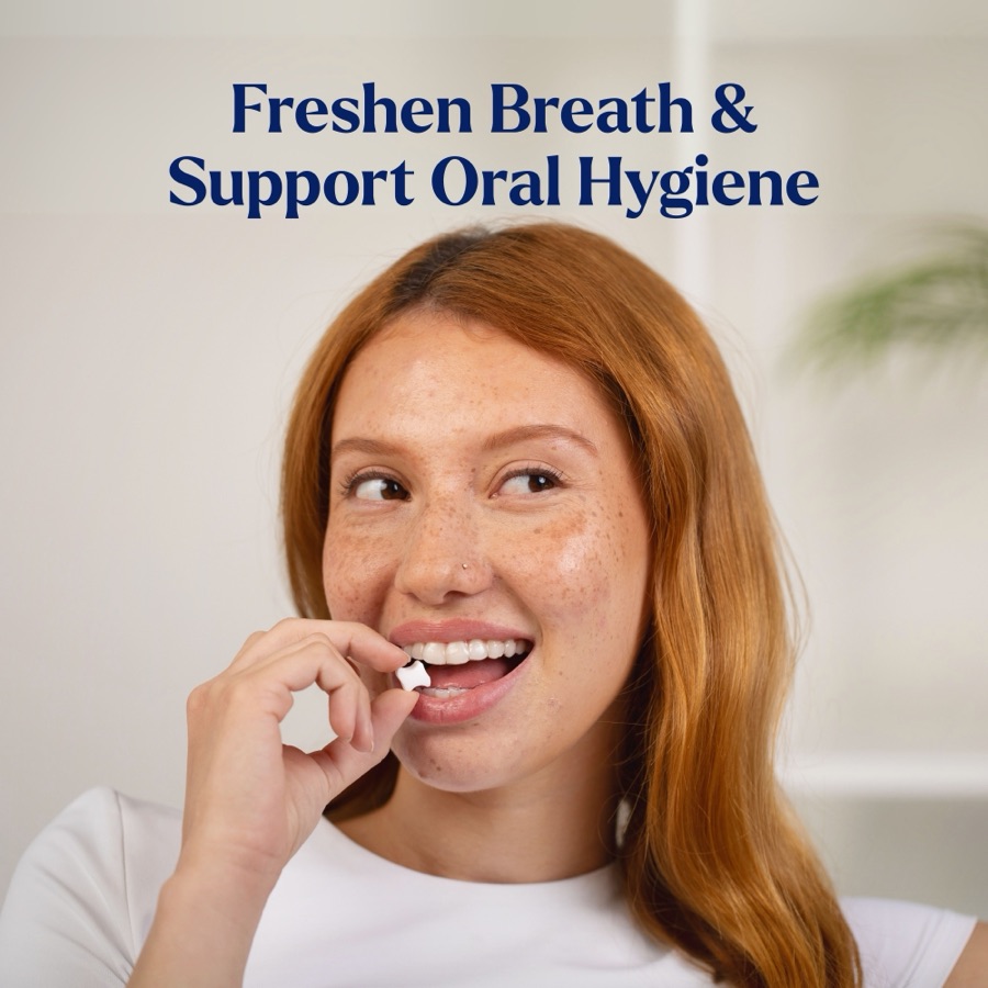 Woman placing a Movemints mint between her aligners